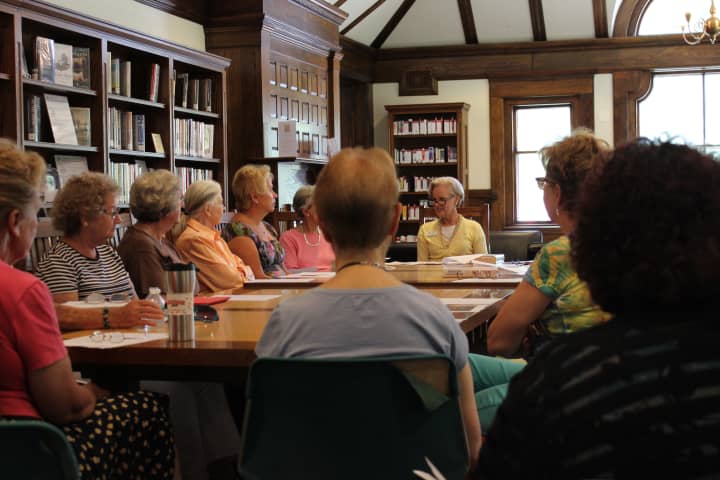 A group of bibliophiles gather in the Pequot Librarys Reading Room for a recent &#x27;Book Chat&#x27; event. 