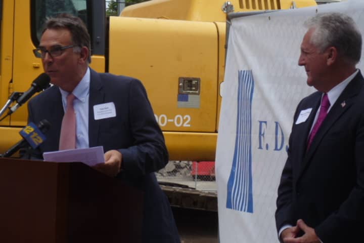 Thomas Rich, president and CEO of F.D. Rich Co., speaks at Monday&#x27;s groundbreaking for SONO Pearl Apartments as Norwalk Mayor Harry Rilling stands by. 