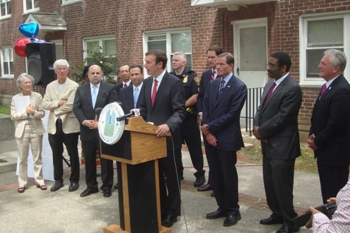 Federal, state and local officials gather at Norwalk&#x27;s Washington Village to announce a $30 million HUD grant to revitalize the housing complex.