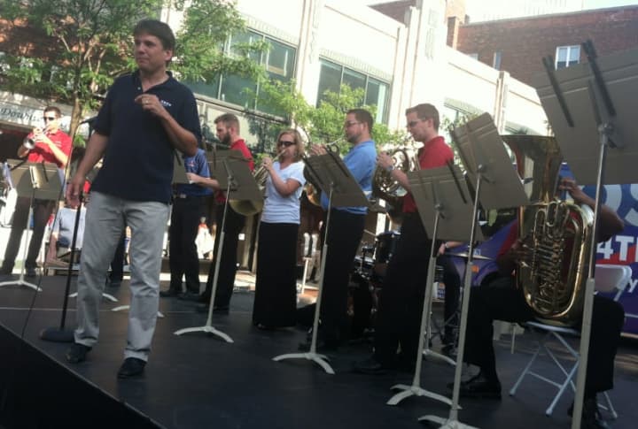 Boston Pops Music Director Keith Lockhart snaps his fingers as a smaller version of his famous orchestra performs on Bedford Street on Monday. The event was held to promote the live web streaming of its popular July 4 concert.