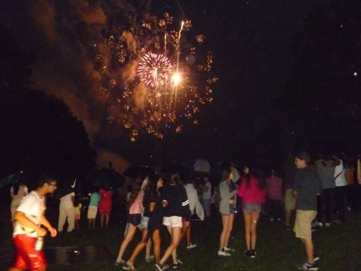 Dozens watched the fireworks display behind White Plains High School Wednesday despite the rain. 
