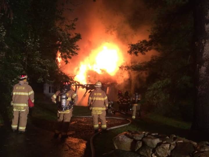 It took Weston firefighters two hours to completely put out a fully involved fire in a two-story barn on Georgetown Road Thursday night. 