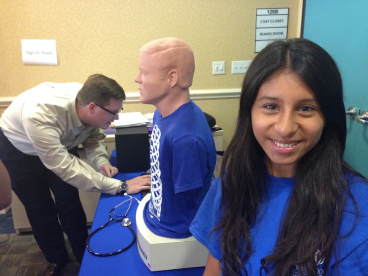 Sofia Huyha, 16, learns how to identify body sounds using a stethoscope on a mannequin. 