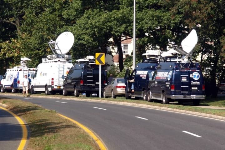 Satellite trucks line Washington Boulevard in Stamford on Oct. 4 as officials investigate the shooting death of a Stamford woman by Capitol Police. Investigators were searching her home for evidence in the case. 