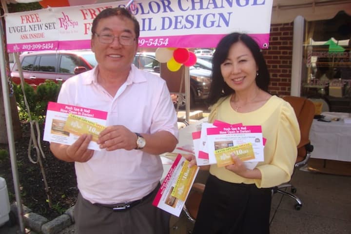 Jason and Esther Su promote the newly opened Posh Spa and Nail at the Darien Sidewalk Sales and Family Fun Days.