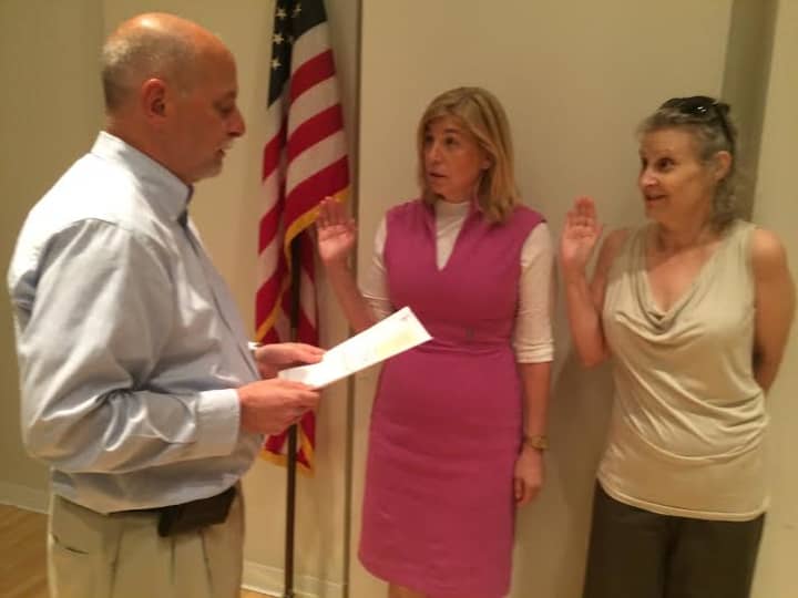 Greg Varian swears in, from left, Haina Just-Michael (president) and Emery Schweig (vice president) to the board of trustees at the New Rochelle Public Library for terms ending in 2019.
