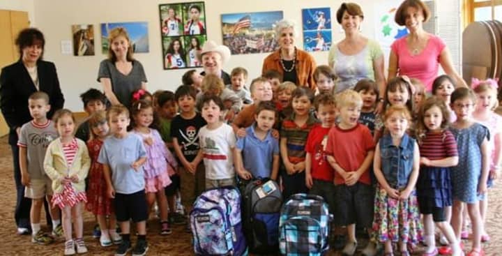 From left, back row, teachers Ora Navok, Stephanie Sherman, Rabbi Mitchell M. Hurvitz, Gail Trell of Starfish Connection, Leslie Kellman and Debbie Berger pose with the kids at the Selma Maisel Nursery School in Greenwich.