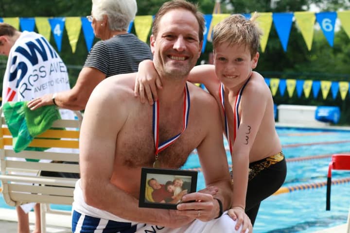 Teddy Meyer swimming with his dad, Scott, in honor of his grandfather in the Chappaqua Swim &amp; Tennis Club&#x27;s Swim Across America fund-raiser, July 13.

