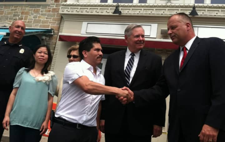 Oscar Moreno, manager of the former Tino&#x27;s nightclub and restaurant, shakes hands with Stamford&#x27;s Public Safety Director Ted Jankowski, while Mayor David Martin looks on. From left are Chief Jonathan Fontneau and Alice Lei, Tino&#x27;s co-owner.