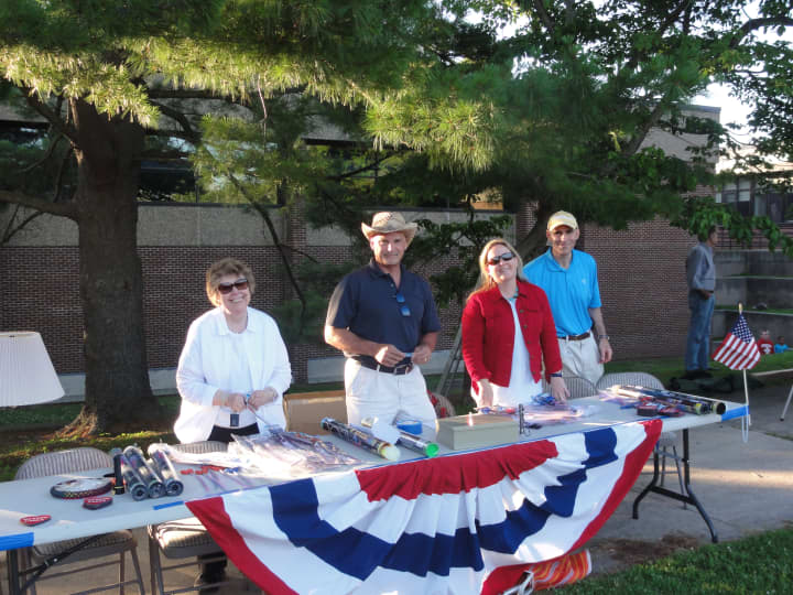 Sharon Gilbert, Mike McGlone, Britta Lerner and Dan Lerner helped to sell glow sticks at Weston&#x27;s July 4th celebration. 