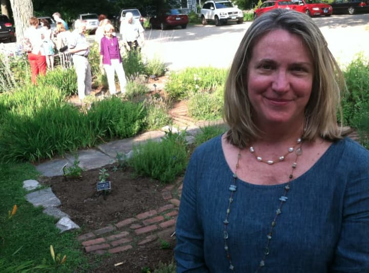 Leslie Nolan, executive director of the Wilton Historical Society, stands in front of the society&#x27;s herb garden. It&#x27;s located at 224 Danbury Road.
