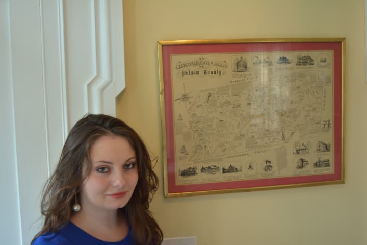 Brewster&#x27;s Erin Meagher, pictured next to an historical map of Putnam County.