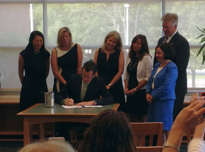 Gov. Dannel P. Malloy signs a new bill that allows school employees statewide to administer epinephrine to students experiencing a serious first-time allergic reaction. 