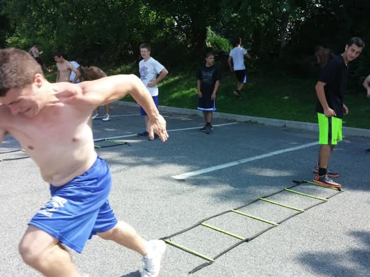 A Carmel High School football players strains for that extra burst during a sprint drill.
