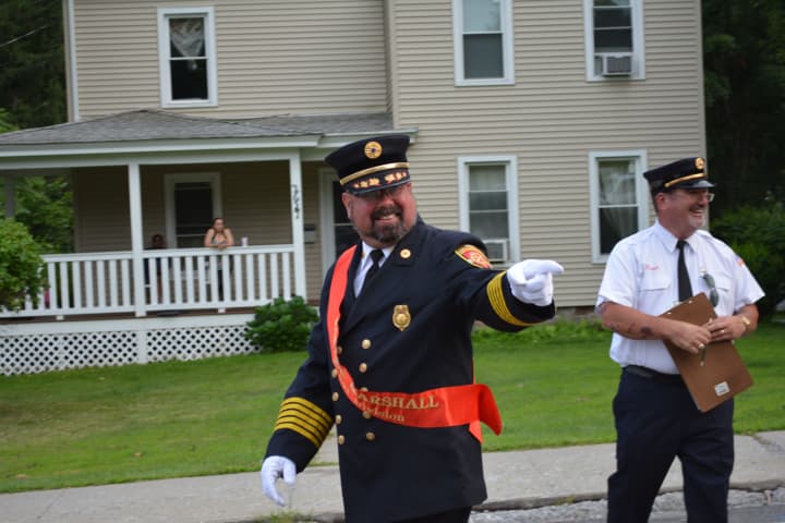 A Brewster parade marshall gestures during his march.
