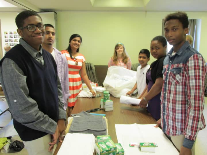 From left are Max Kinlock, Joshua Wyclif, Christina Wyclif, Amber Bobwich, Solomon Wyclif, Khadijah Morgan and Jovan Perry prepare health kits.