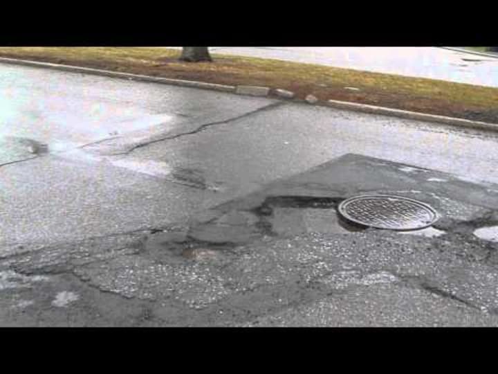 Some potholes, cracks and crevices on Saxon Woods Road in White Plains.