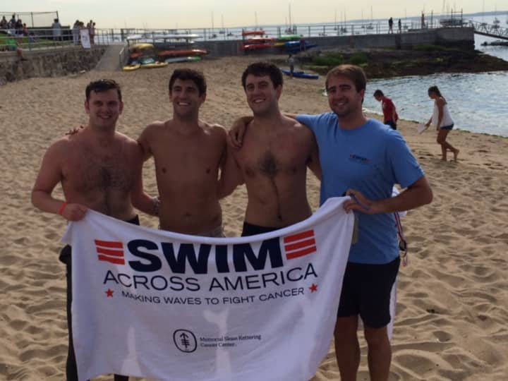 Young swimmers dry off after swimming to raise funding for cancer research and awareness at the Swim Across America-Long Island Sound Swim on July 26.