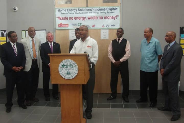 Lorenzo Wyatt of Mr. Handyman, surrounded by Norwalk clergymen and Mayor Harry Rilling, discusses how residents can use state programs to save money on home energy costs.