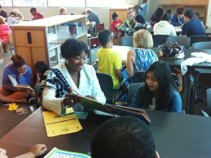 State Sen. Andrea Stewart-Cousins reads one-on-one with a second-grader at the Yonkers Public Library. 
