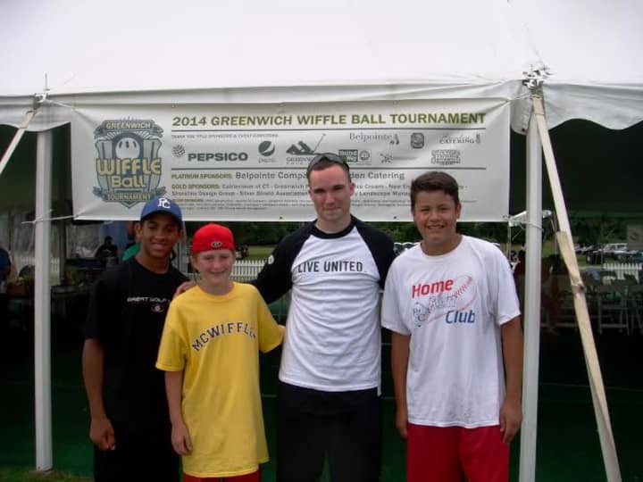Brendan Mick, left, a Wiffle event organizer for the United Way, with a team of young players at the 2014 Town Wiffle Tourney.