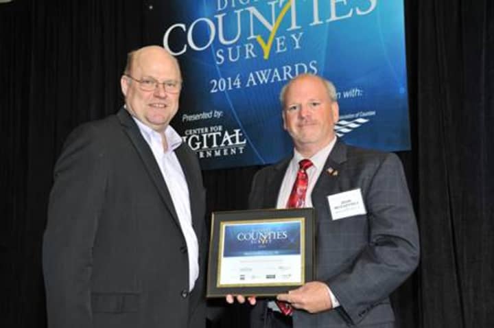 John McCaffrey, commissioner of the Westchester County Department of Information Technology, accepts award from Todd Sander, executive director of the Center for Digital Government, at the 2014 Digital Counties award ceremony in New Orleans.