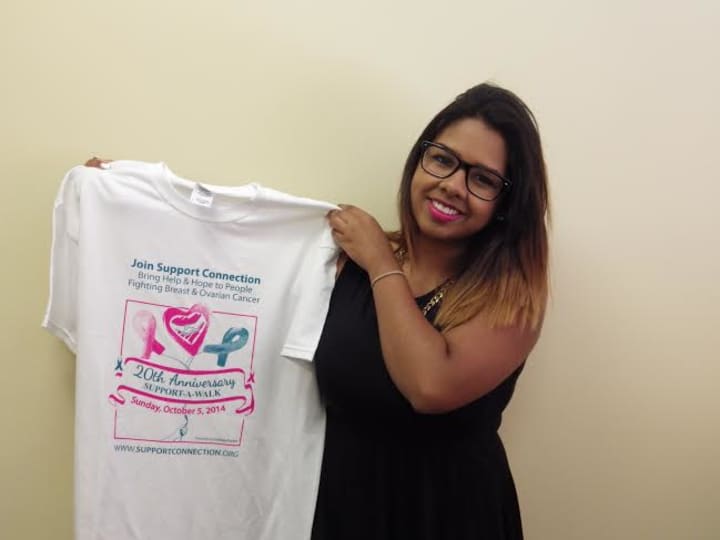 Lindsey Torres of Peekskill, NY, holding the Support-A-Walk tee-shirt that features her winning design.