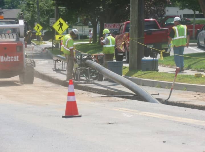 Workers put in the 8-inch polyethylene pipe in front of the Village Market on Old Ridgefield Road in Wilton. Work began Friday and is expected to be completed by the end of November.