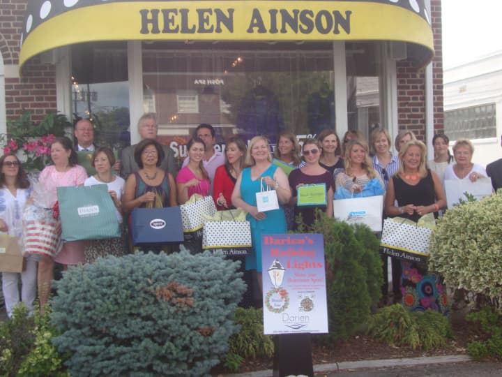 Members of the Darien Chamber of Commerce gather outside Helen Ainson to celebrate the upcoming sales tax-free shopping week, which begins Aug. 17.