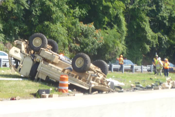 A Connecticut Army National Guard light medium tactical vehicle overturned on I-95 after collided with a sedan Thursday, Aug. 7.