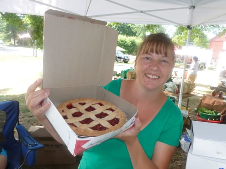 Michelle Tartaglio of Stratford holds up a pie from Oronoque Farms Bakery &amp; Boutique of Shelton at Wilton Farmers Market.