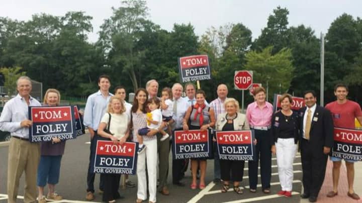 Tom Foley turns up at the polls with a large group of family and supports.