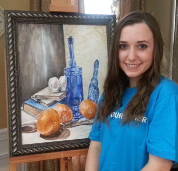 Becca Raffo with one of art pieces that will be displayed at the Somers Library.