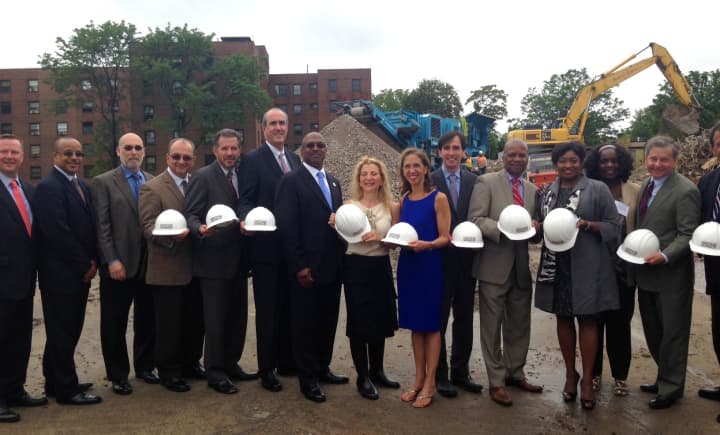 Rella Fogliano (Center) breaks ground with dignitaries at the construction site of Phase II of the Heritage Homes housing development.