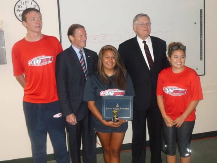 Brenda Moratoya, center, of Stamford is honored Wednesday for saving the life of a teenager in a near drowning on Aug. 6. From left is lifeguard Richard Glass, U.S. Sen. Richard Blumenthal, Mayor David Martin and lifeguard Leann Moy.