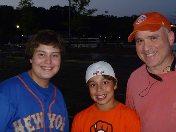 From left, Evan, Joshua and Ken Greenberg at the Celebrity All-Star Softball Game in New Rochelle at Flower Park Wednesday. 