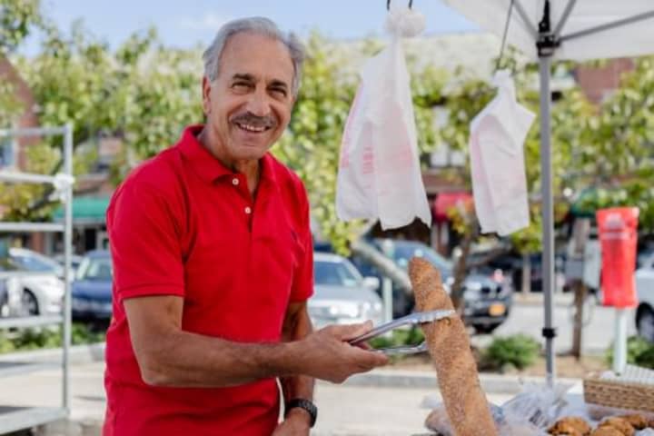 Antonio Amato of Eastchester selects fresh Italian bread from a Market vendor.