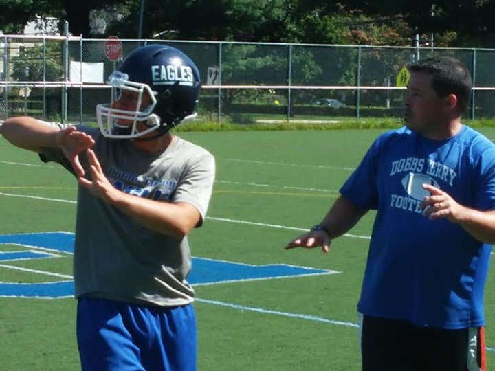 Dobbs Ferry head football coach Jim Moran works through a pass-and-defend drill during the second day of summer practice on Tuesday, Aug. 19