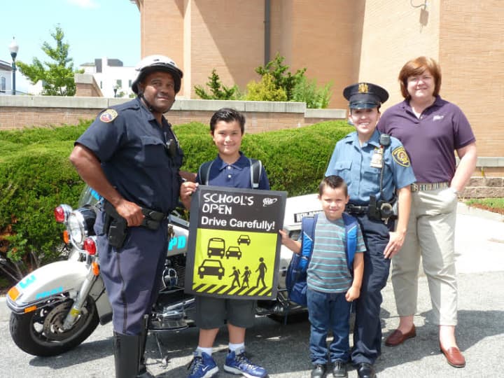 Police Officer Kenny Hudson and Detective Lillian Sanchez along with students Eddie Hayes, left, Armando Sanchez and AAA spokeswoman Barbara Ward.