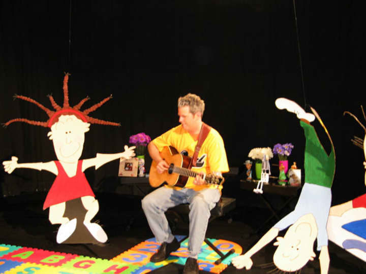 Musician Kurt Gallagher will entertain children with song and instruments at the Farmers Market on the New Rochelle Library Green on Saturday.