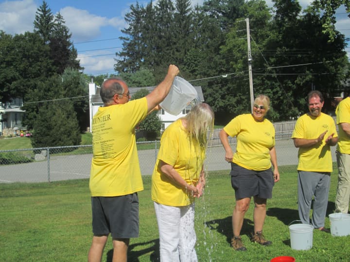 Supervisor Linda Puglisi gets a bucket of ice water dumped over her to raise money for ALS. 