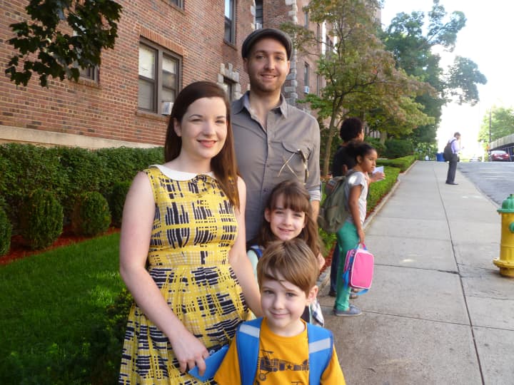 Andrew (back right) and Karen Binder (left) wait for the school bus with their children Shane, 5, and Cassia, 8. 