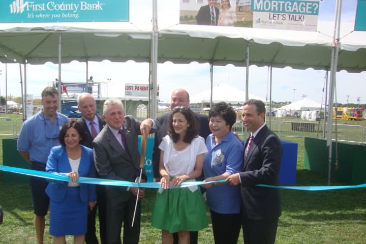 Norwalk officials, the Norwalk Seaport Association and First County Bank celebrate the upcoming Oyster Festival with a ribbon cutting Wednesday.