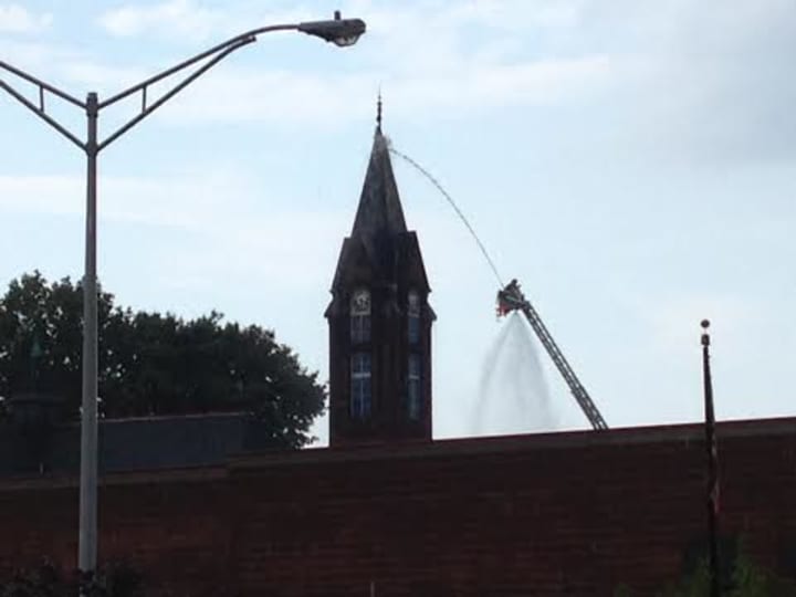 Firefighters attack the blaze on the steeple at Little Zion Church of Christ, 4 Martin Luther King Jr. Drive, South Norwalk. 