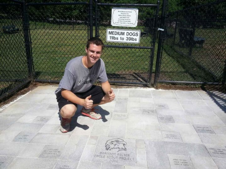 Brandon Pelter at the newly completed entrance to the dog park.
