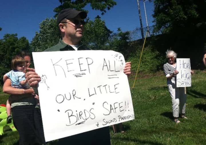 Fairfield residents hold a protest in June as they seek to have sound barriers built at the I-95 northbound rest area. Kurt Potter holds a sign saying barriers would help protect the nearby bird sanctuary.