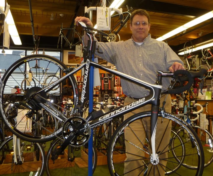 Mike Conlin stands behind a cutting-edge bike at Outdoor Sports Center.