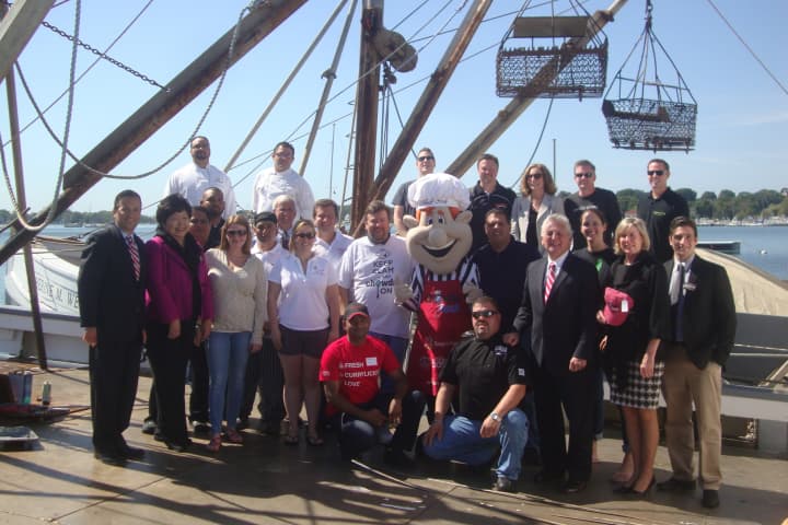 Chowdafest organizers, restaurant owners and Norwalk officials gather on an oyster boat to celebrate the annual culinary competition coming to Calf Pasture Beach this year.