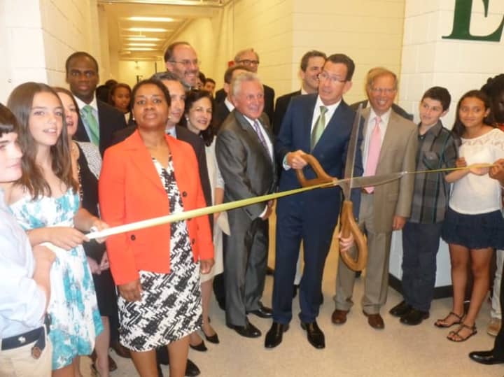 Gov. Dannel P. Malloy prepares to cut the ribbon at the official opening of the Norwalk Early College Academy at Norwalk High School on Friday. NECA allows students to earn a high school diploma and a two-year degree from Norwalk Community College.