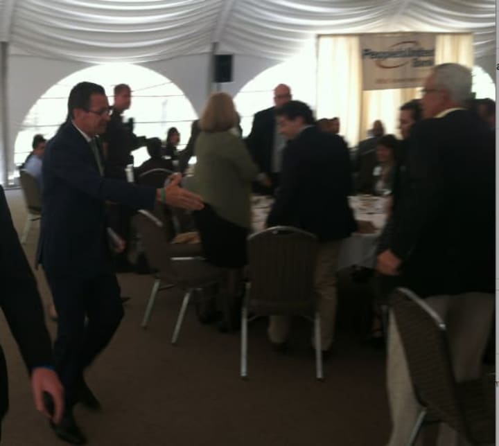 Gov. Dannel P. Malloy defends his record while speaking at the Stamford Chamber of Commerce&#x27;s annual meeting Friday.